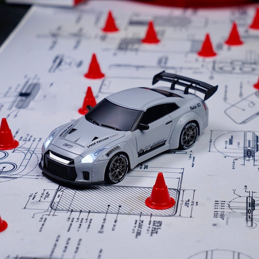 Model car on technical drawings with red cones