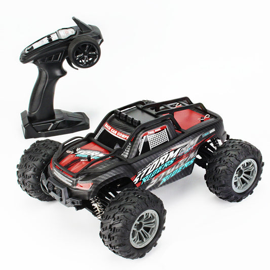 1/16 4WD off-road RC monster truck with 2.4GHz pistol remote, red Storm Riders body and oversized all-terrain tires.