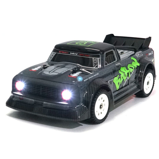 Black and green RC car with glowing headlights on a white background