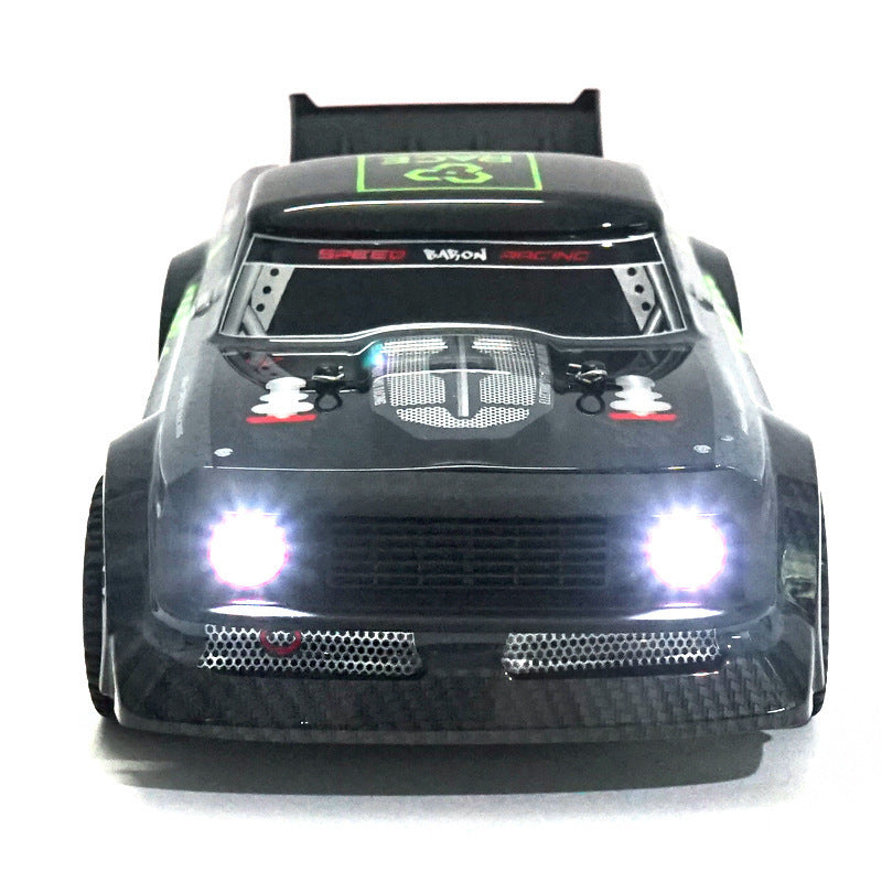 Black remote control car with glowing headlights on a white background