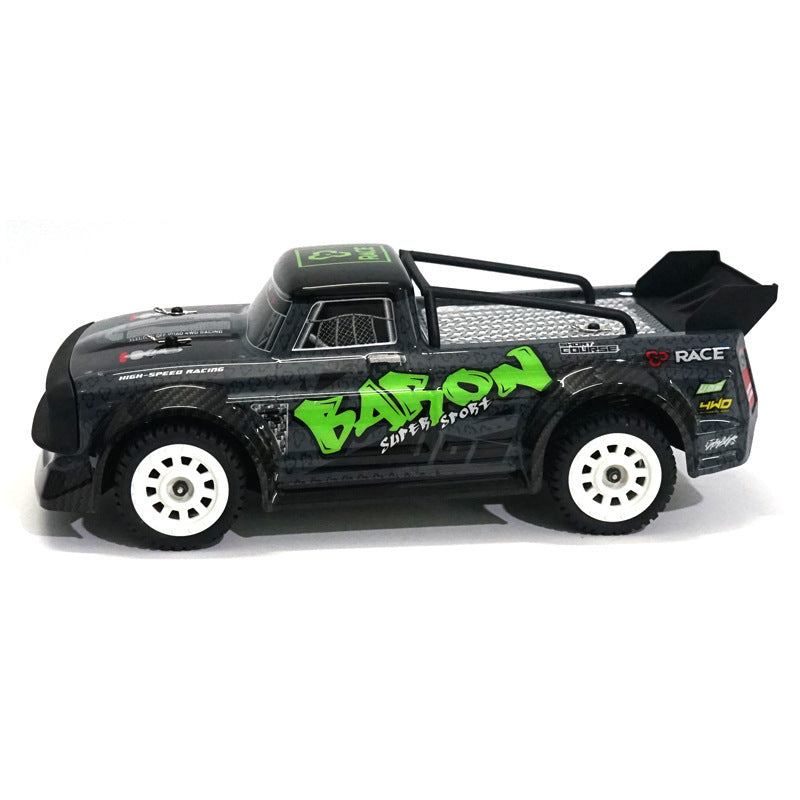 Black toy truck with green and white text on a white background