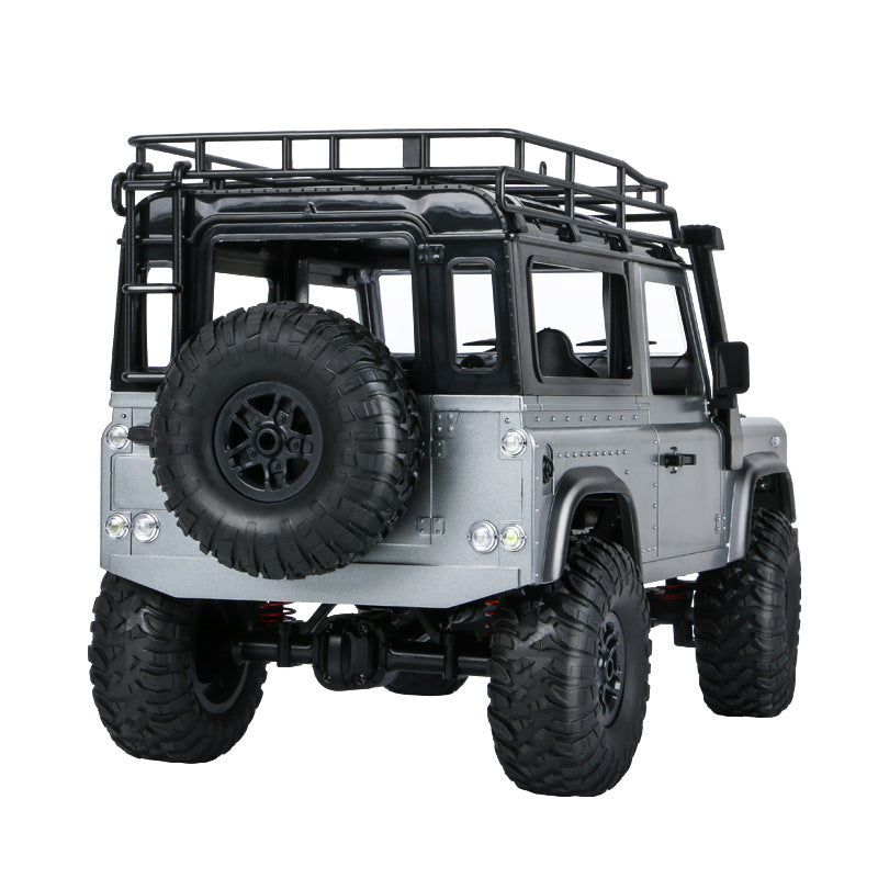 Rear view showing spare tire and suspension details on RC Defender-style truck.