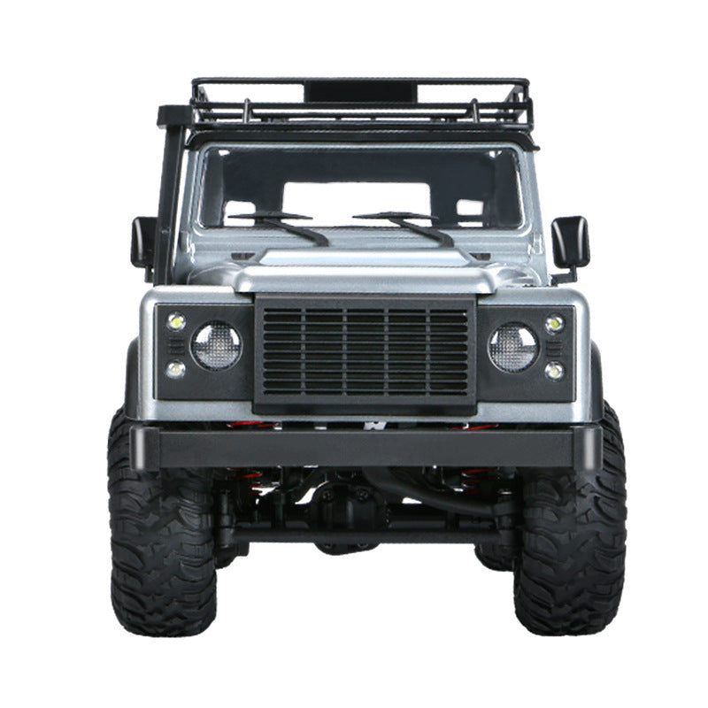 Front view of Land Rover-style RC crawler with black bumper and LED headlights.