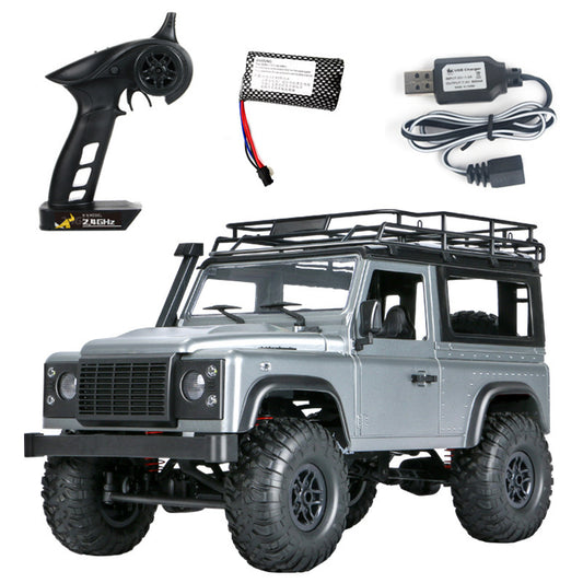 Model of a Land Rover with remote control, battery, and USB cable on a white background