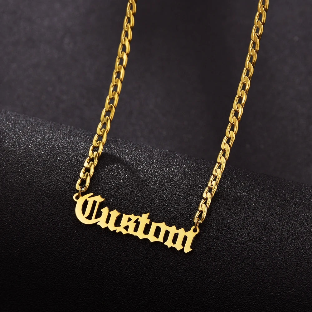Gold chain necklace with 'Custom' pendant on a black background