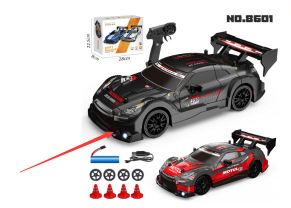 Toy racing car set with remote control, parts, and accessories on a white background