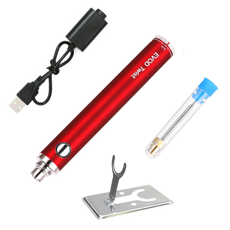 Red EVOD Twist mini soldering iron set with adjustable voltage, USB charging cable, spare soldering tip in protective tube, and metal support stand.