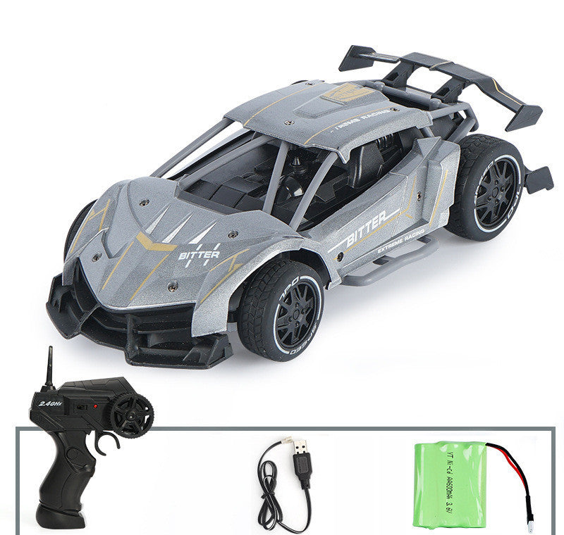 Toy car with remote control, USB cable, and battery on a white background