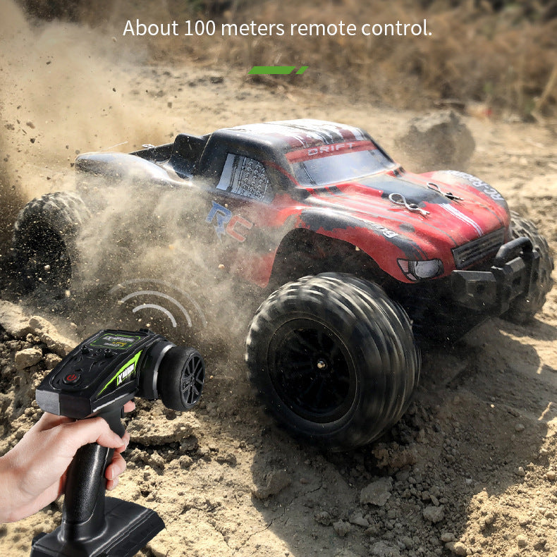 Red RC drift truck with 2.4GHz remote racing across dirt terrain