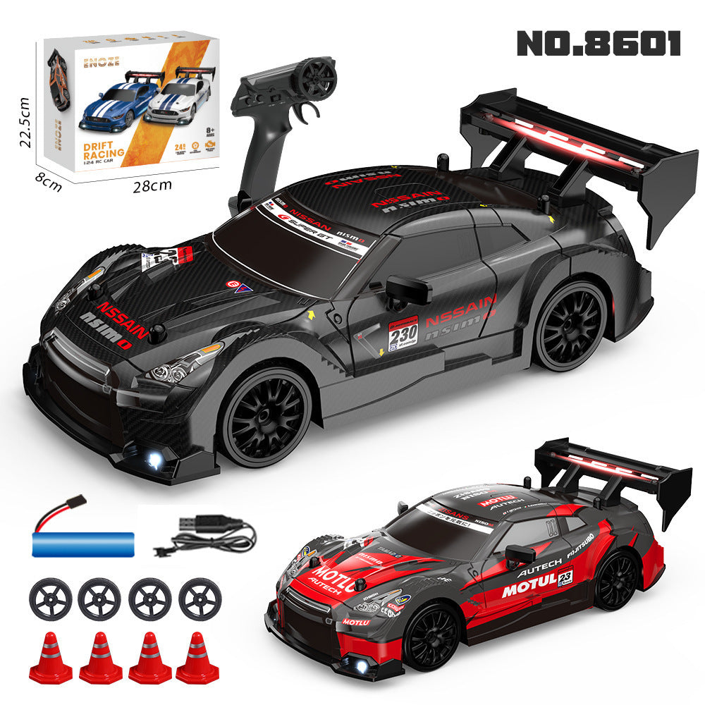 Toy car with remote control, accessories, and packaging on a white background