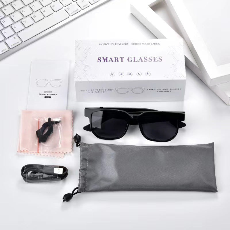 A pair of black smart Bluetooth audio glasses with a square design, promoting features such as music listening and phone call functionality.