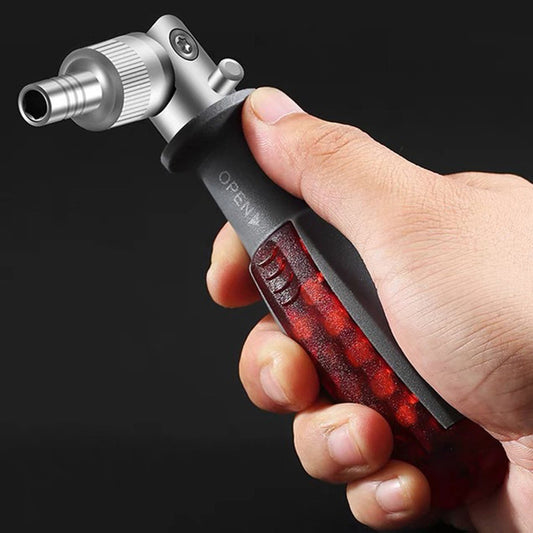 A hand holding a screwdriver with a red and black handle and a metallic ratchet mechanism.