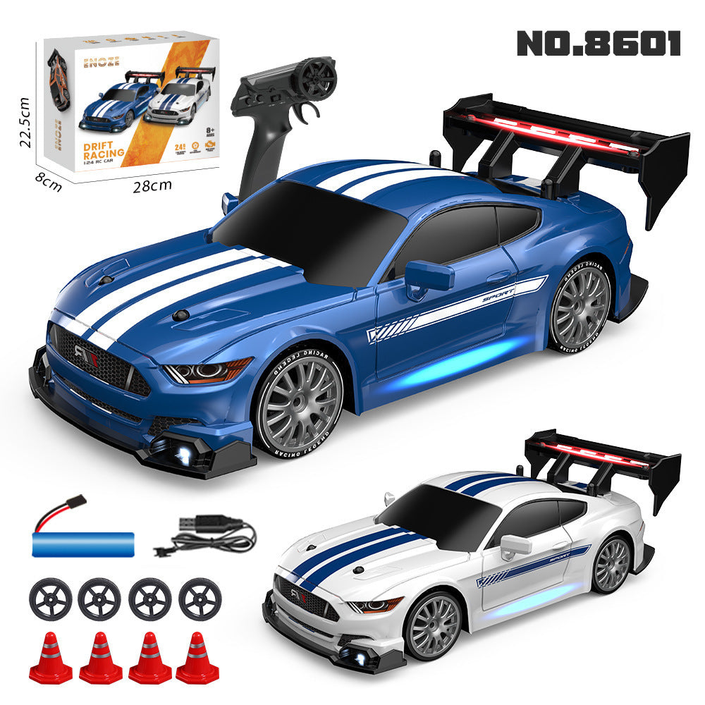 Blue and white toy car with remote control, accessories, and packaging on a white background