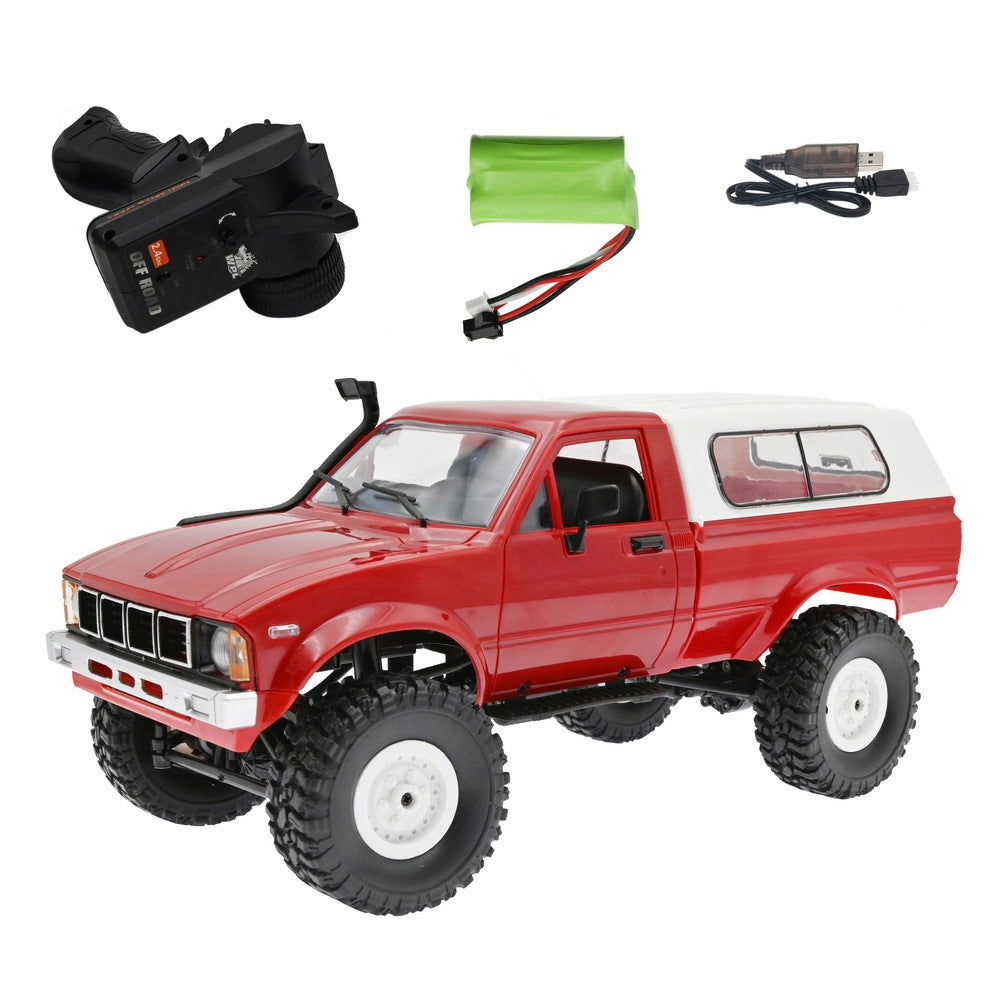 Red off-road model truck with accessories on a white background