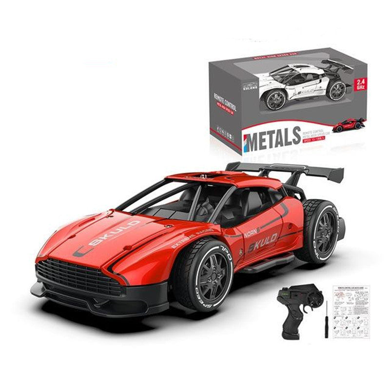 Red toy car with black details and a remote control, displayed in front of its packaging.