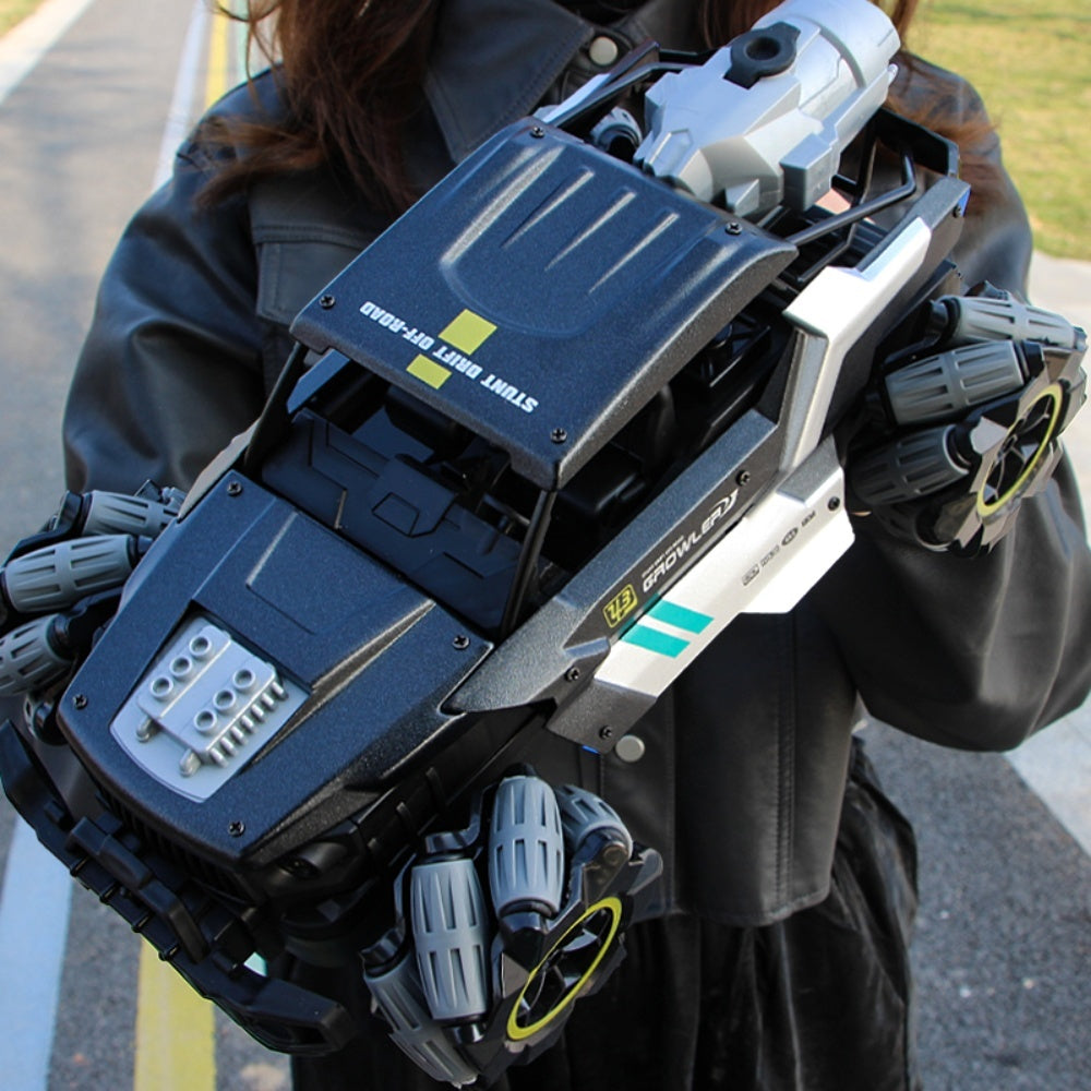 Large stunt off-road RC car held by person, showcasing rugged wheels and futuristic body design