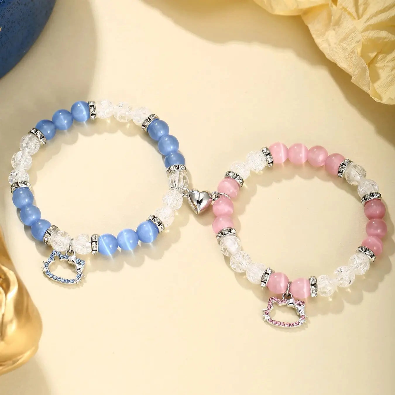 Two beaded bracelets with heart charms on a light background