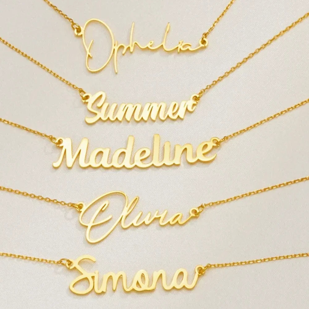 Gold name necklaces displayed on a light background