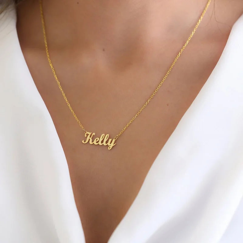Gold necklace with 'Kelly' pendant on a white background