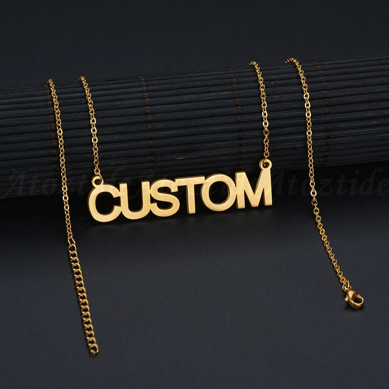 Gold necklace with 'CUSTOM' pendant on a black background