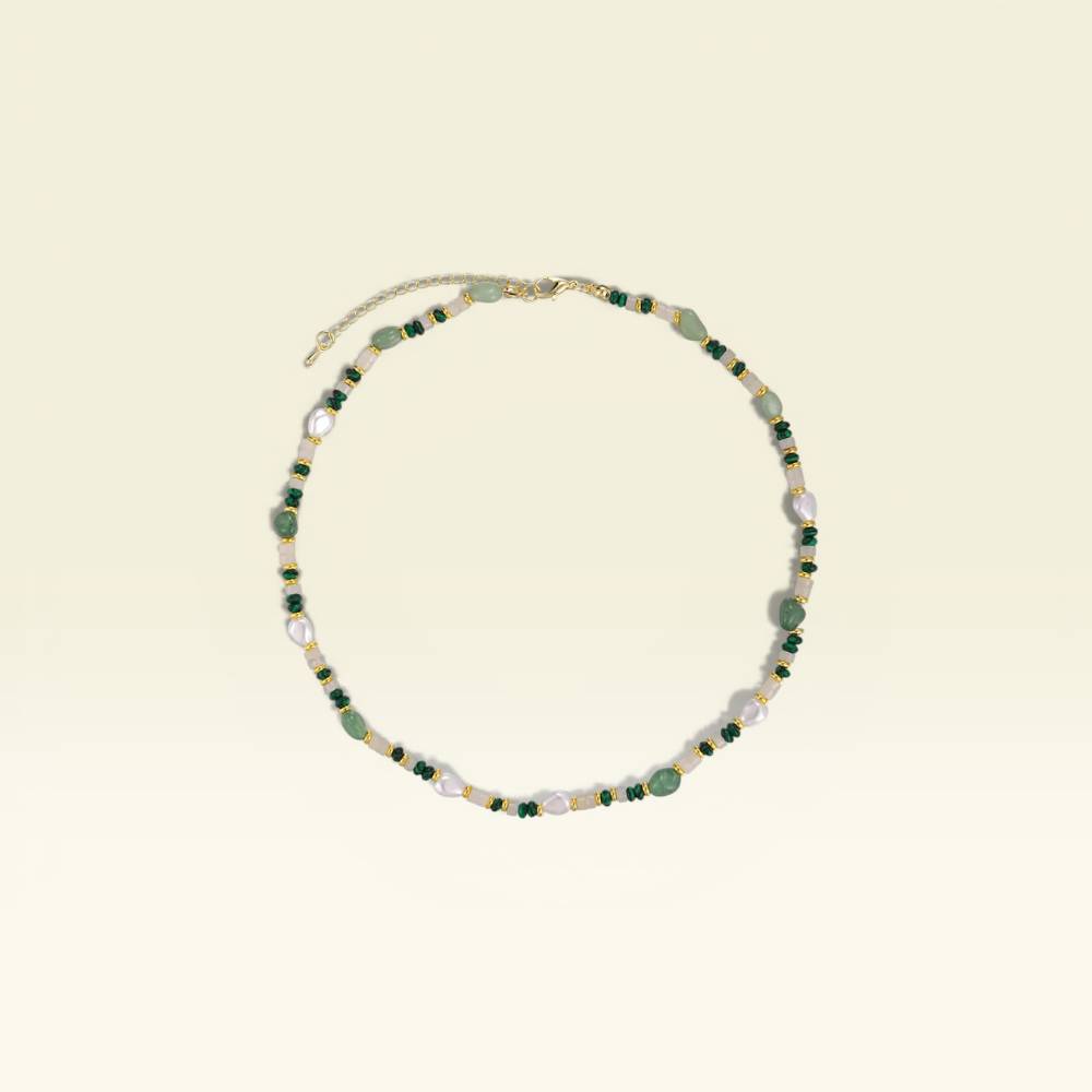 Necklace with green and white beads on a beige background