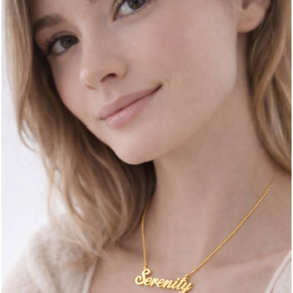 Woman wearing a gold 'Serenity' necklace against a neutral background
