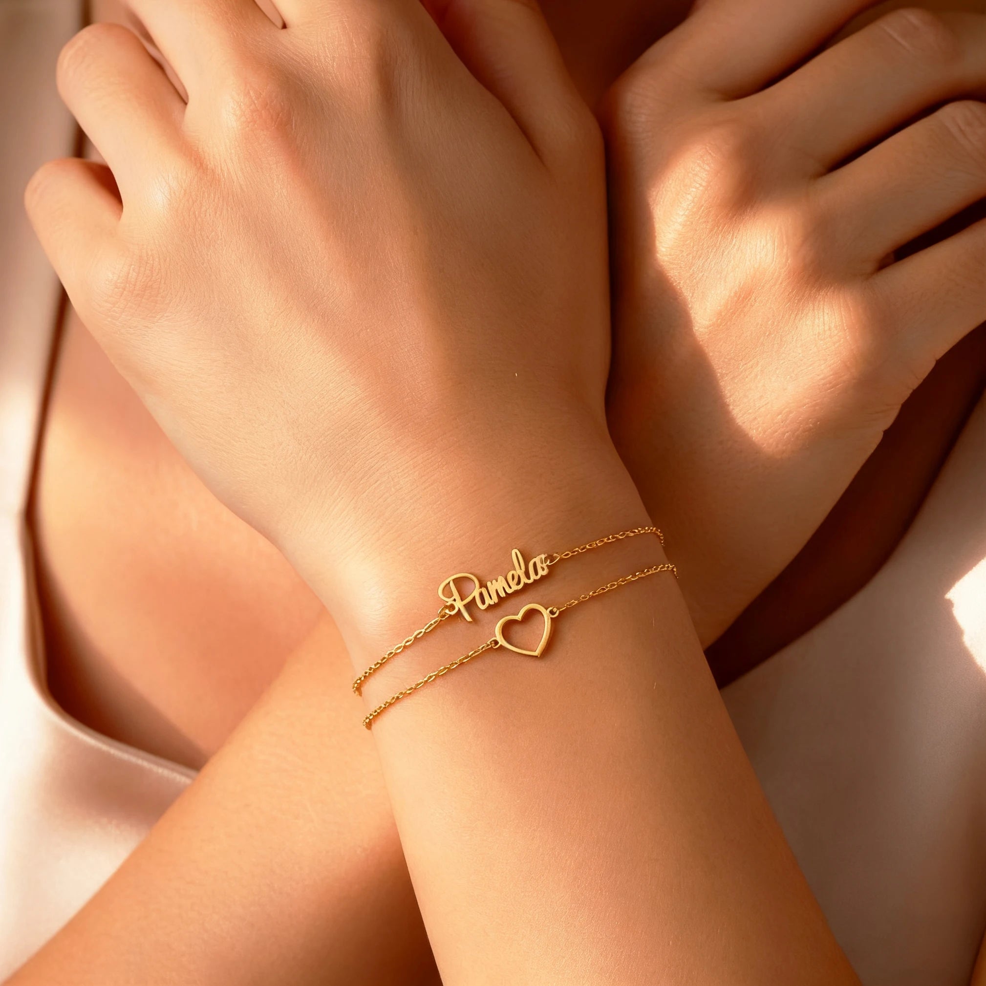 Gold bracelet with heart design on a person's wrist
