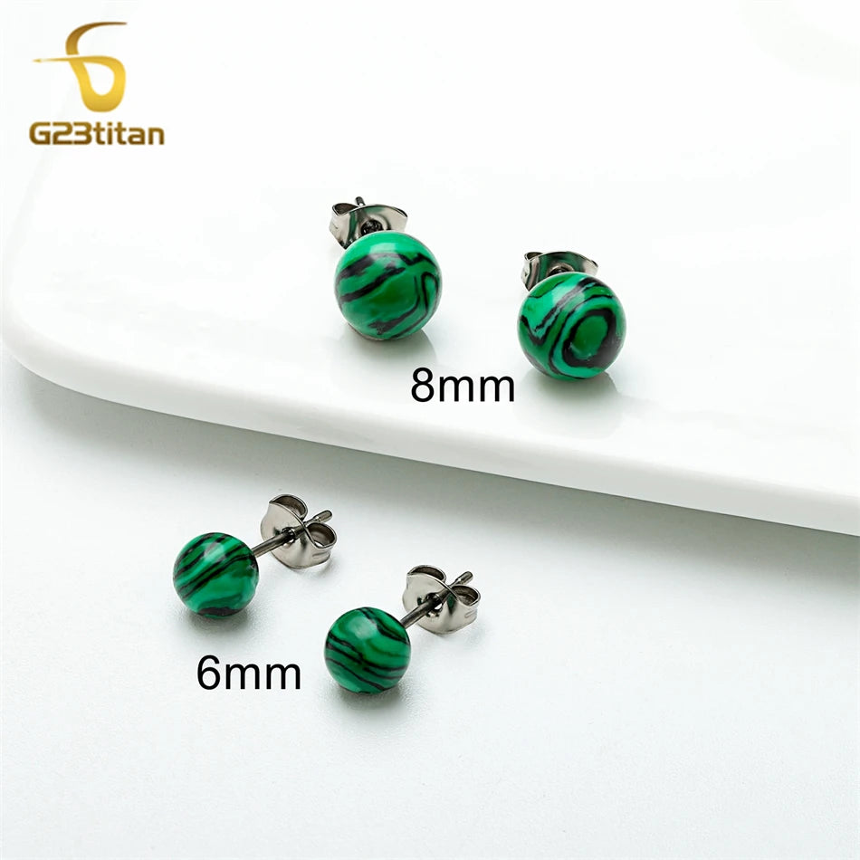 Green marbled earrings with 'G23Titan' branding on a white surface.