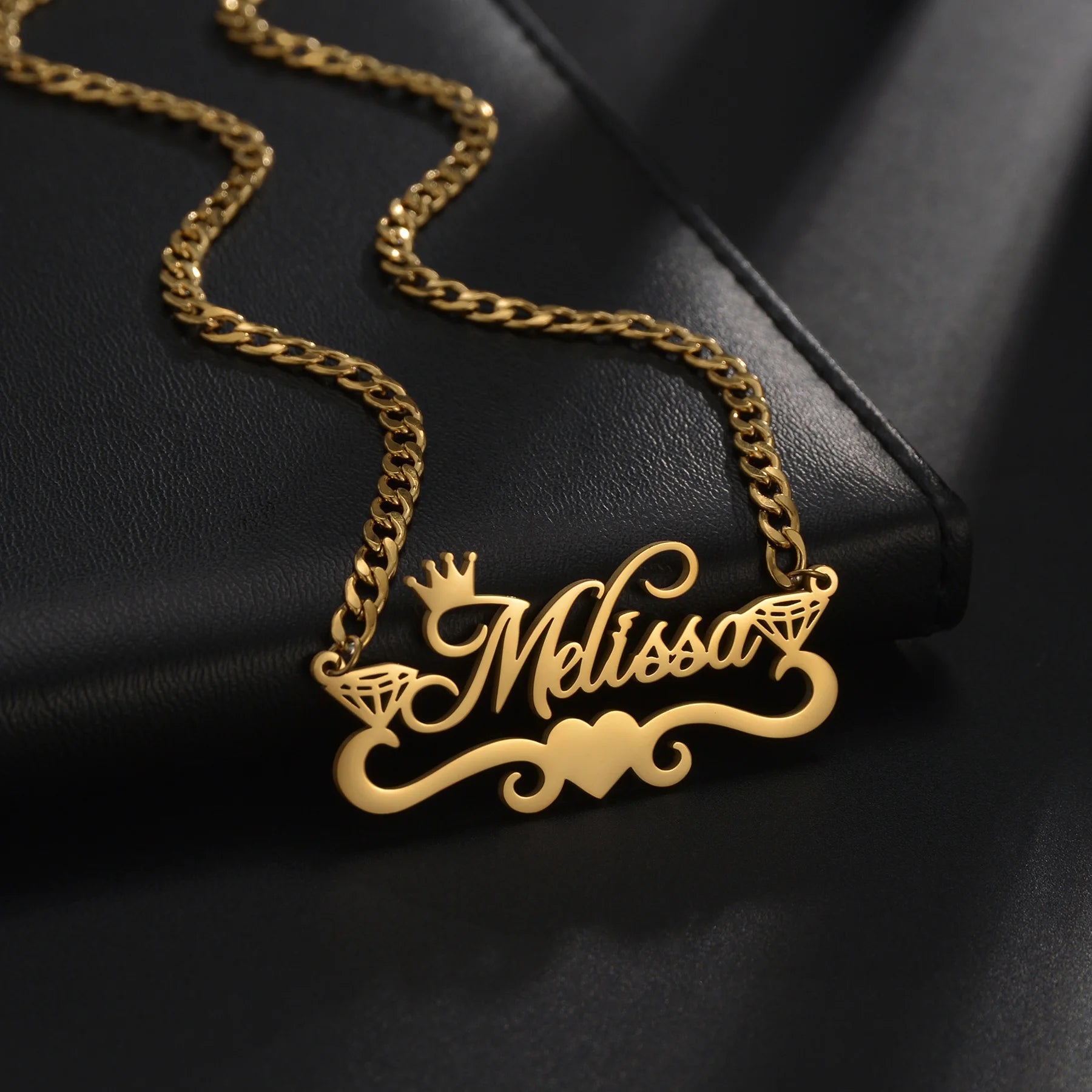 Gold necklace with 'Melissa' pendant on a black background