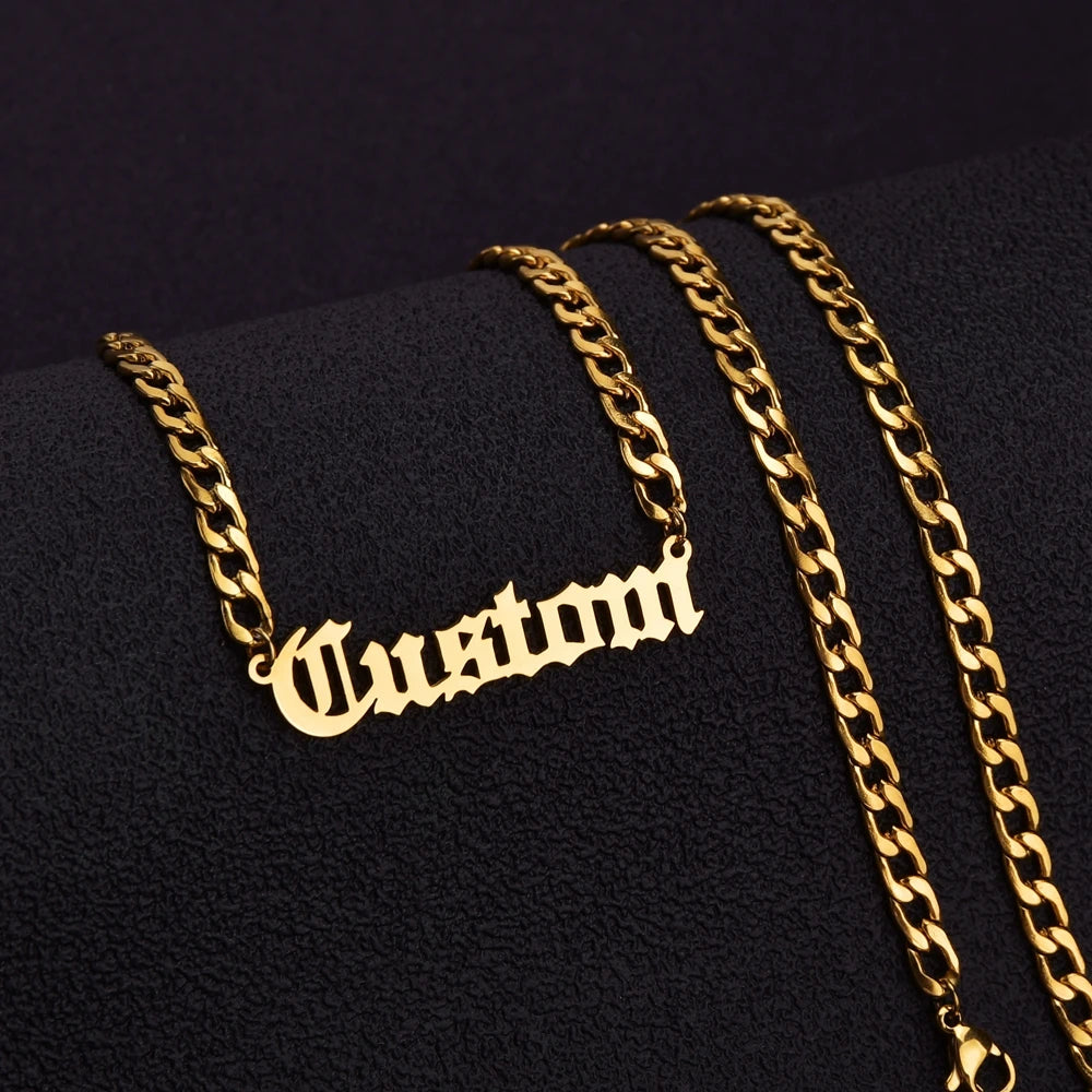 Gold chain necklace with 'Custom' pendant on a black background