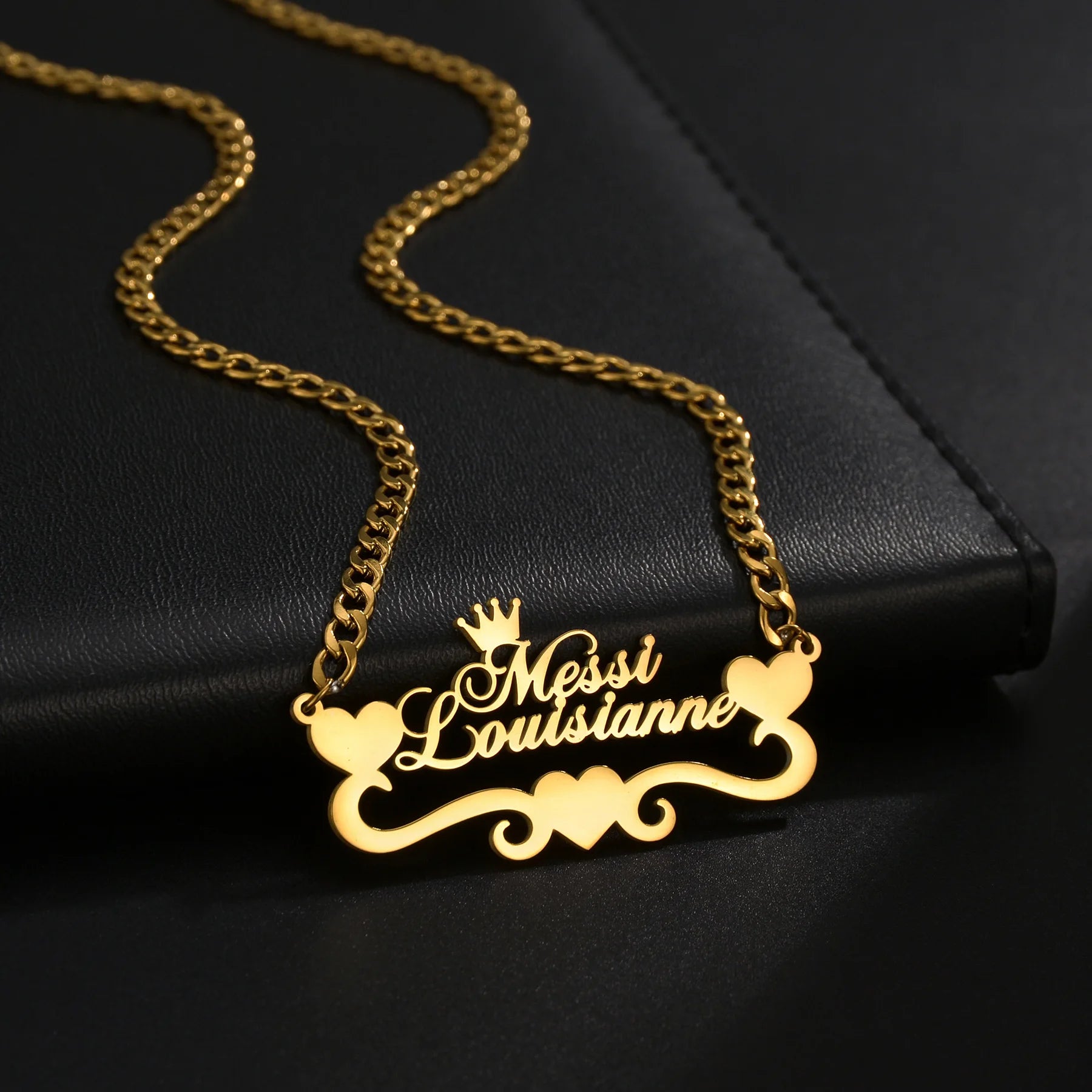 Gold necklace with 'Messi Louistine' pendant on a black background