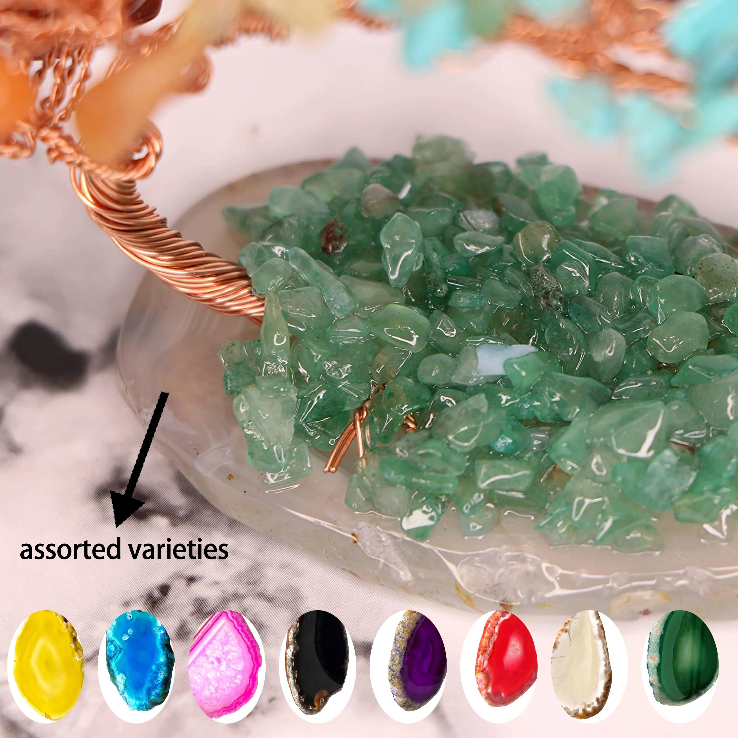 Assorted green crystal stones on a stone base with a copper wire frame, surrounded by color swatches.