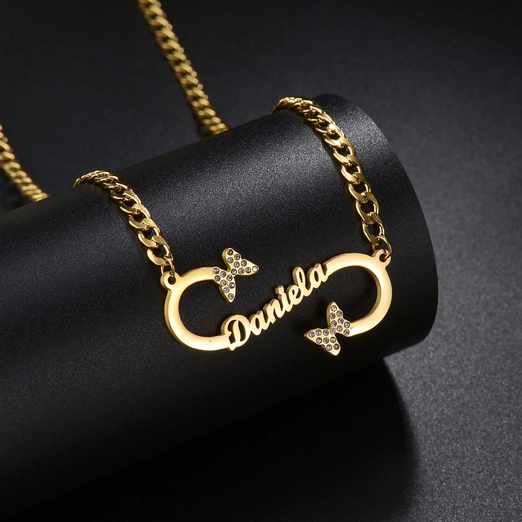 Gold necklace with 'Daniela' on a black background