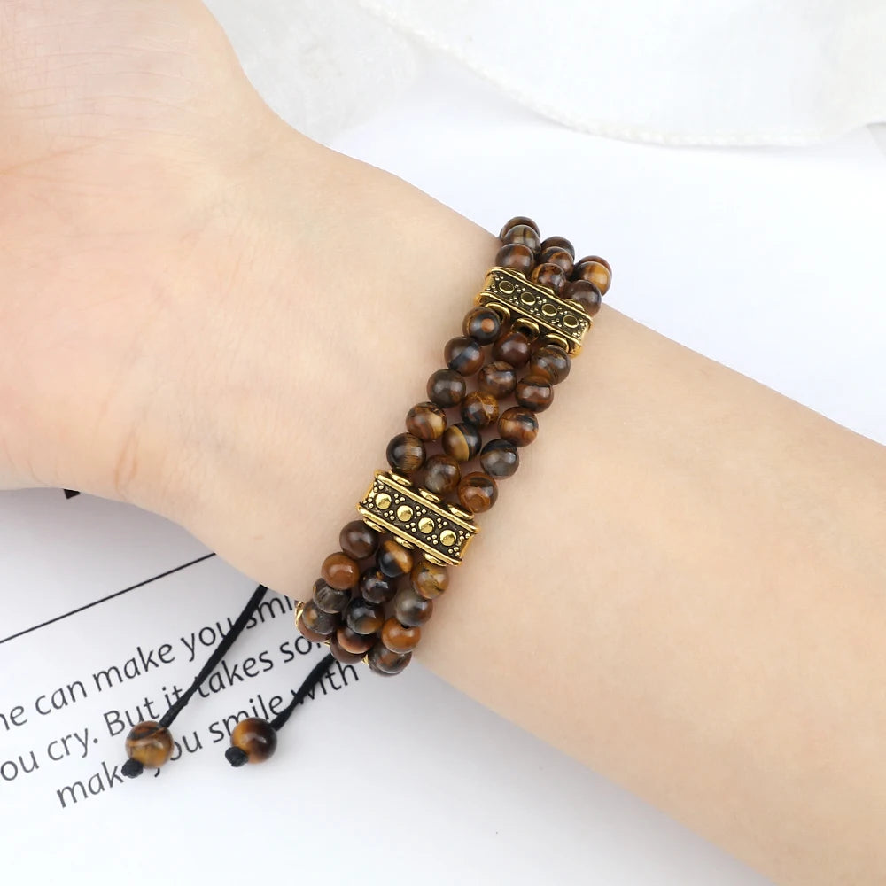 Beaded bracelet with gold accents on a wrist against a white background