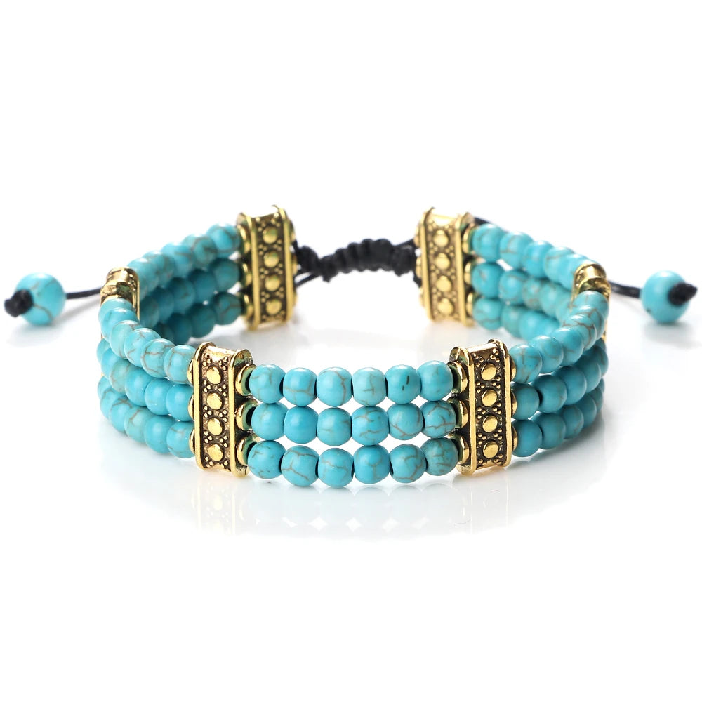 Turquoise beaded bracelet with gold accents on a white background