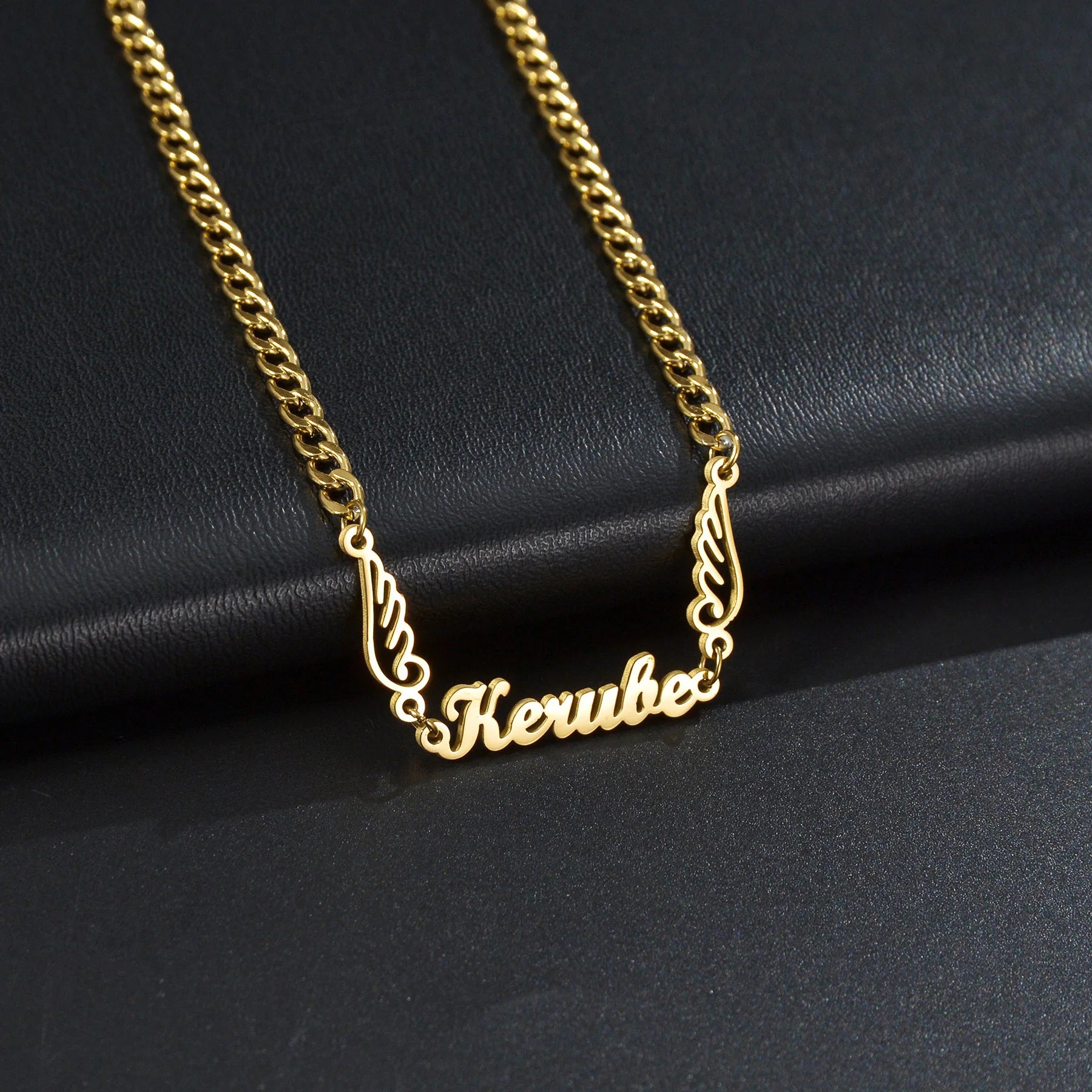 Gold chain necklace with 'Kerub' pendant on a black background