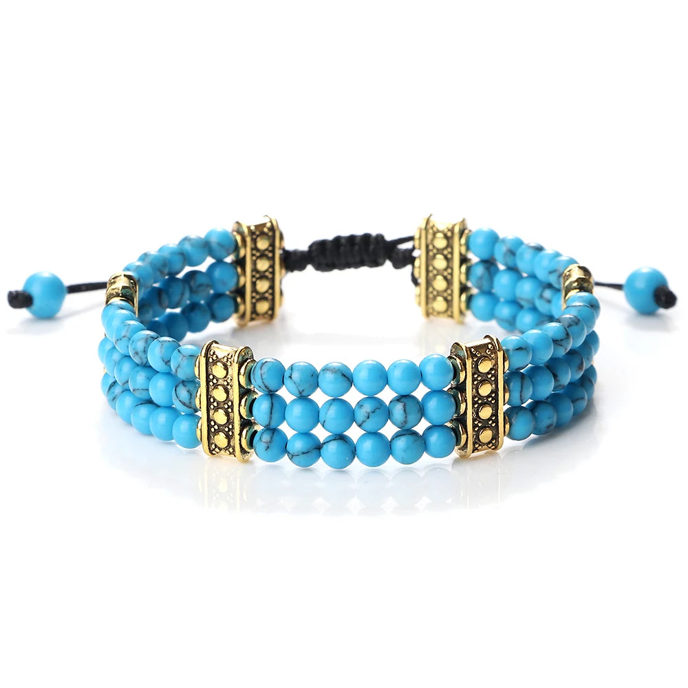 Turquoise beaded bracelet with gold accents on a white background
