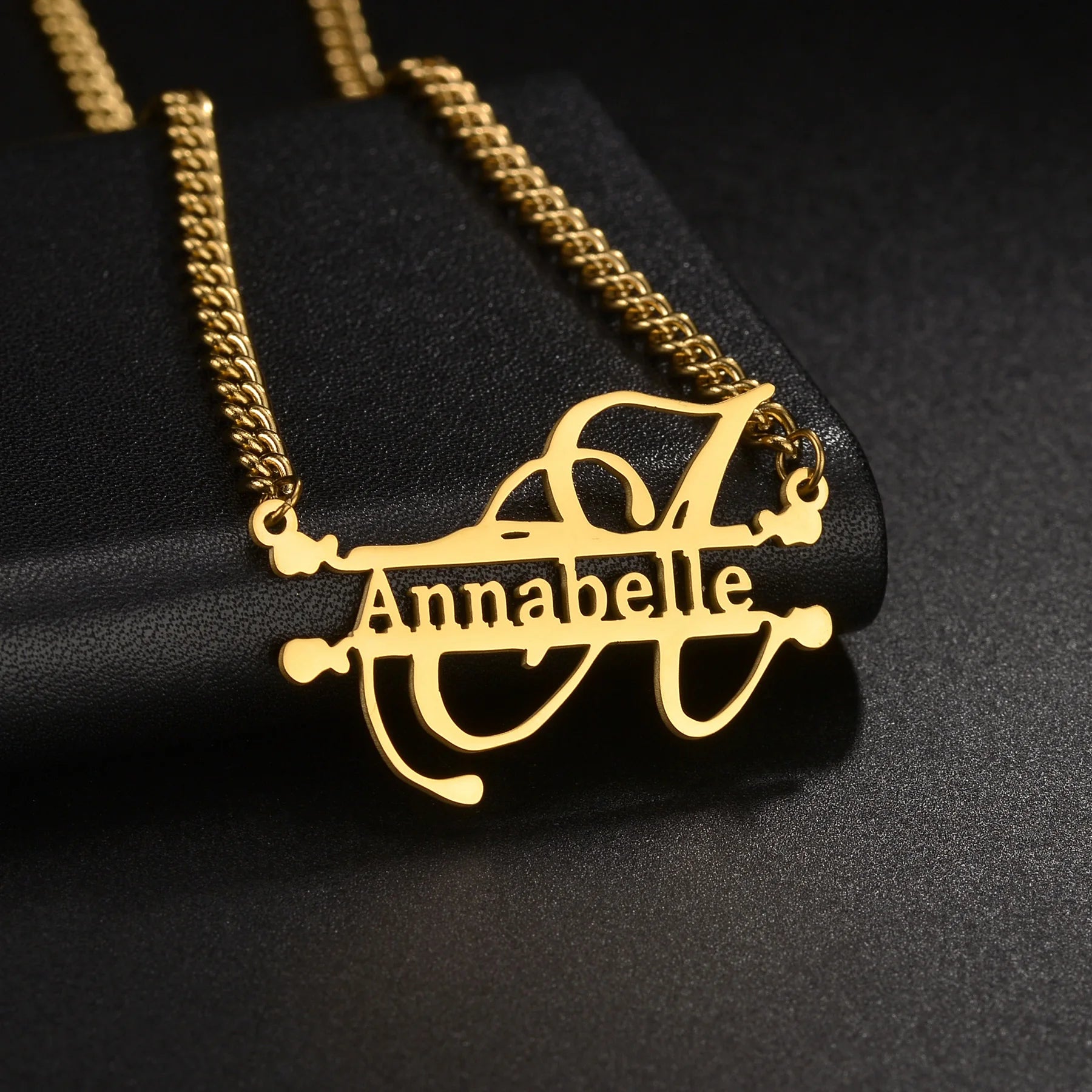Gold necklace with 'Annabelle' pendant on a black background