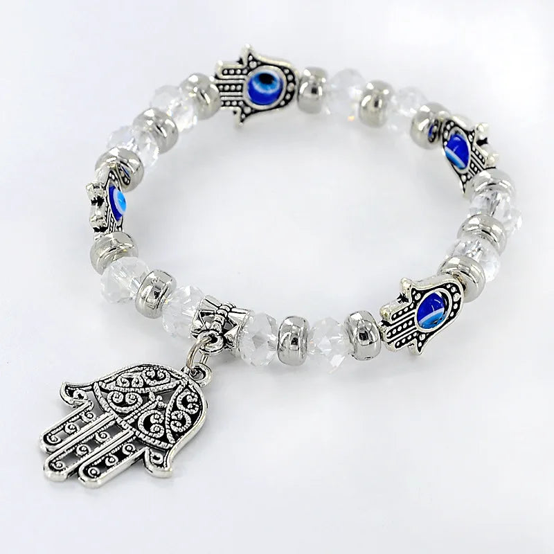 Bracelet with Hamsa hand and eye charms on a white background