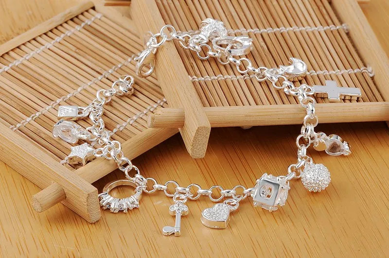 Silver charm bracelet on a wooden surface
