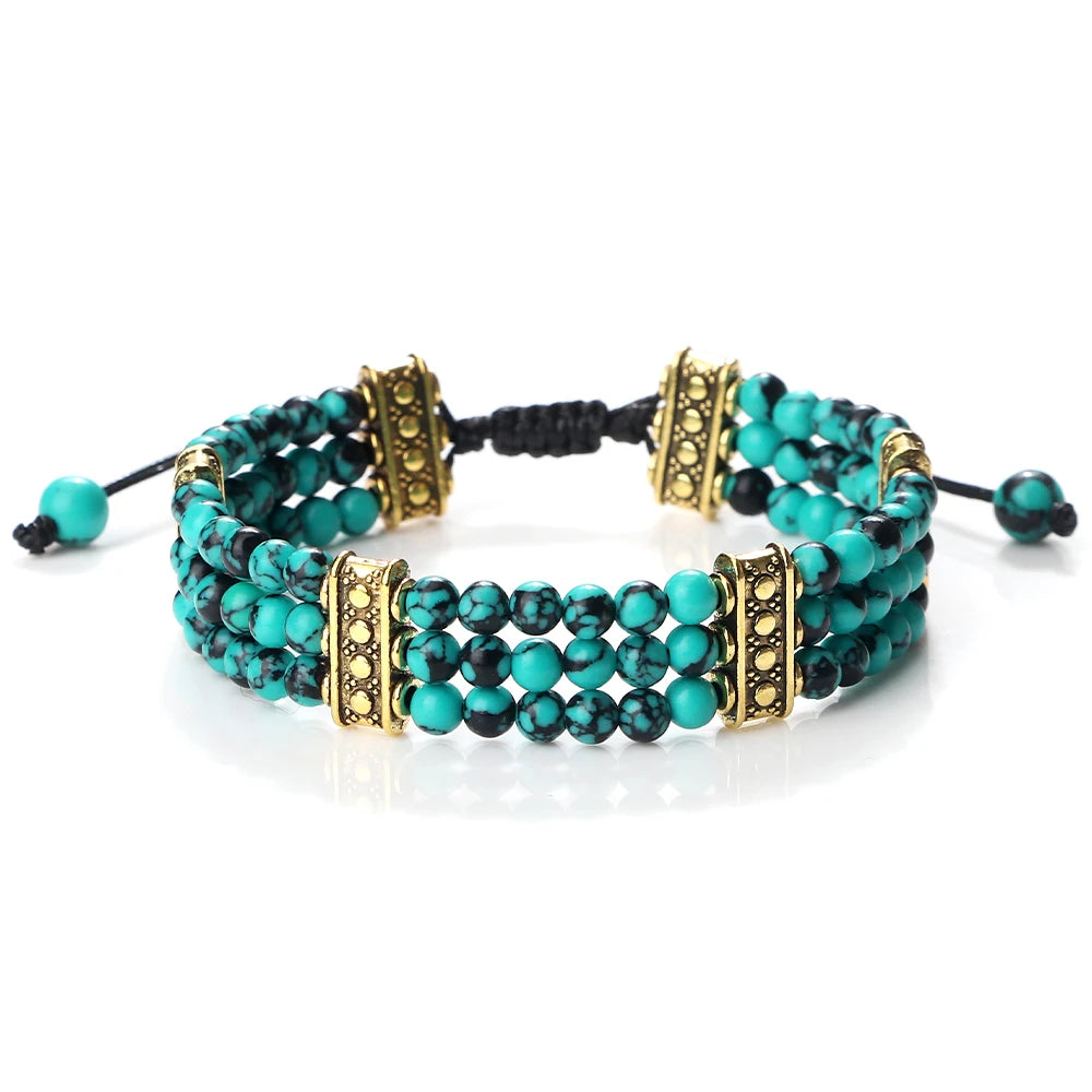 Turquoise beaded bracelet with gold accents on a white background