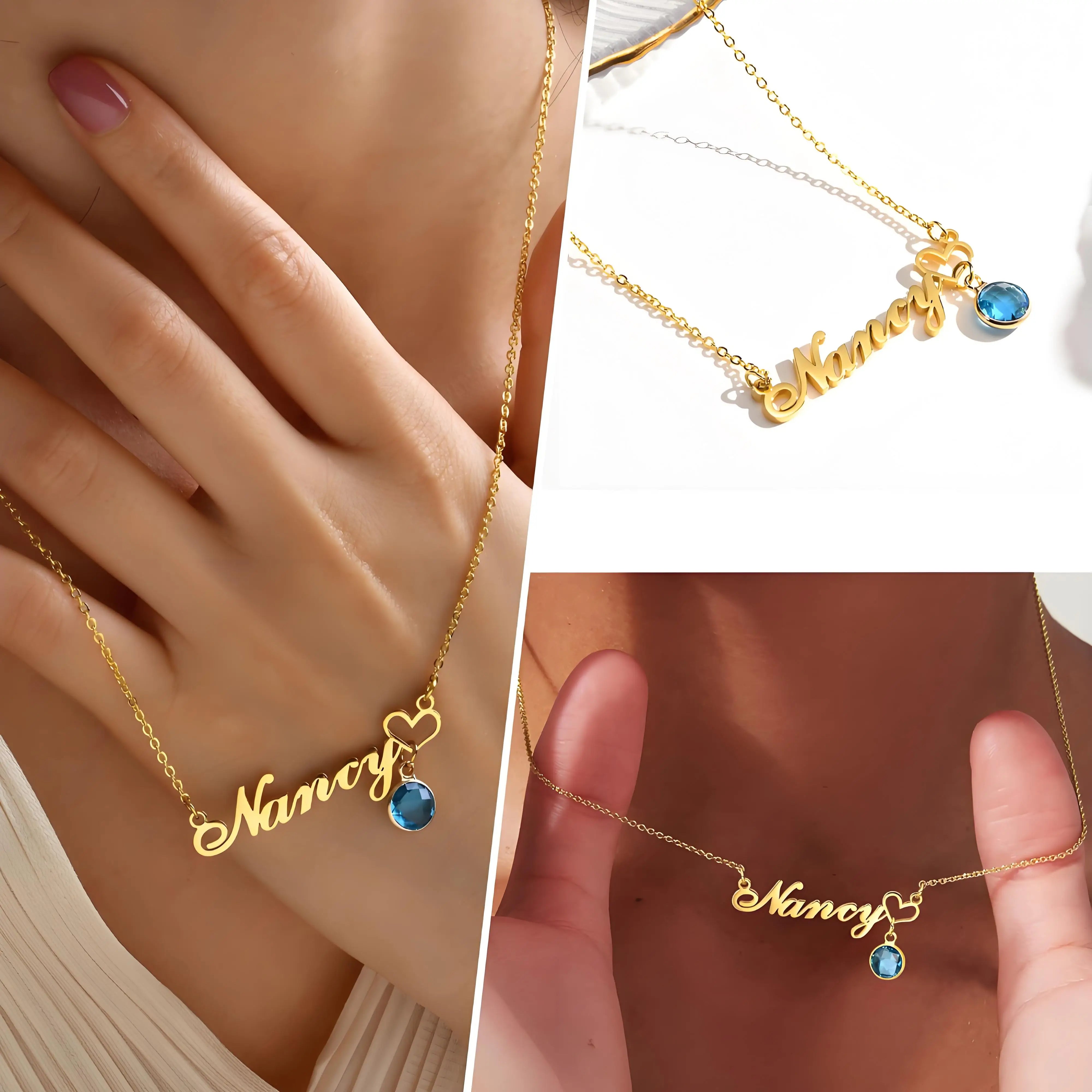 Gold necklace with 'Nancy' and blue gemstone on a hand, close-up view.
