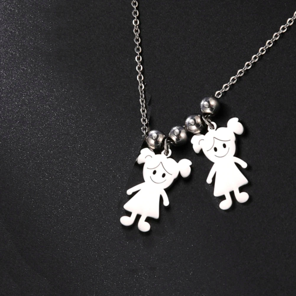 Necklace with two white pendant figures on a black background