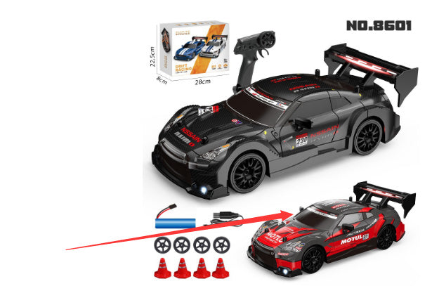Toy car set with remote control, packaging, and accessories on a white background