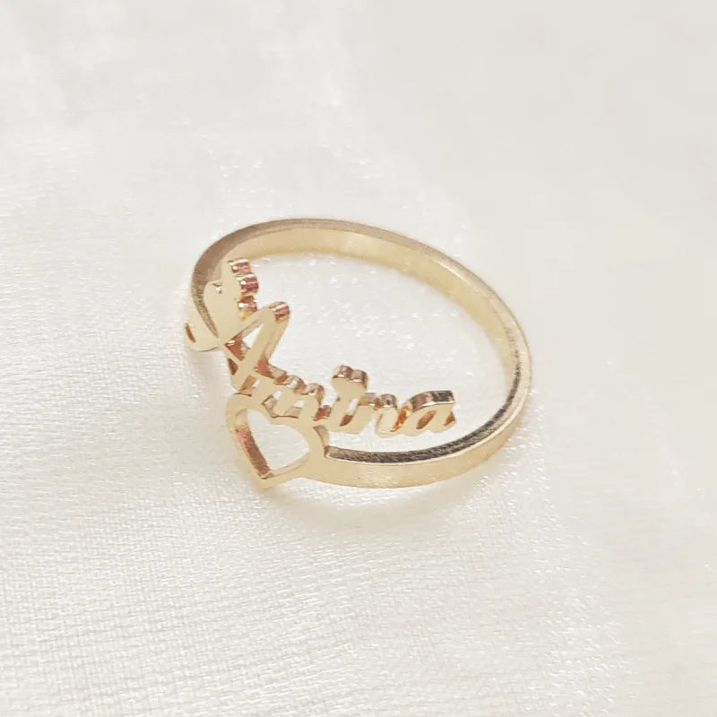 Gold ring with 'Alfie' engraved on a white background
