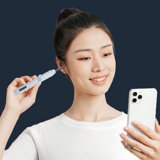 Smiling woman using smart ear cleaner while viewing real-time visuals on smartphone, demonstrating wireless app connectivity and safe ear cleaning.