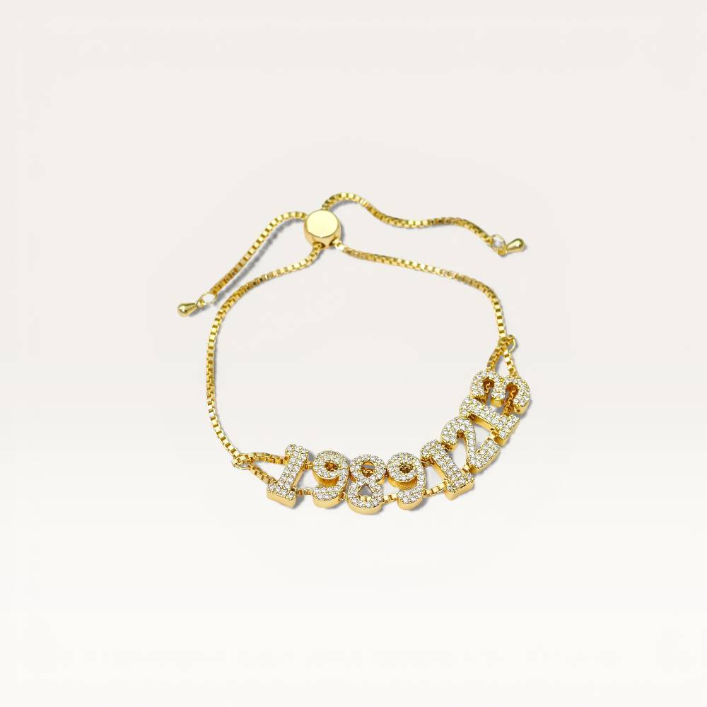 Gold bracelet with circular design on a light beige background