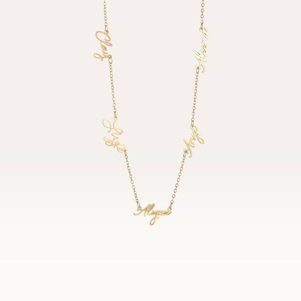 Gold necklace with script-style letters on a light beige background