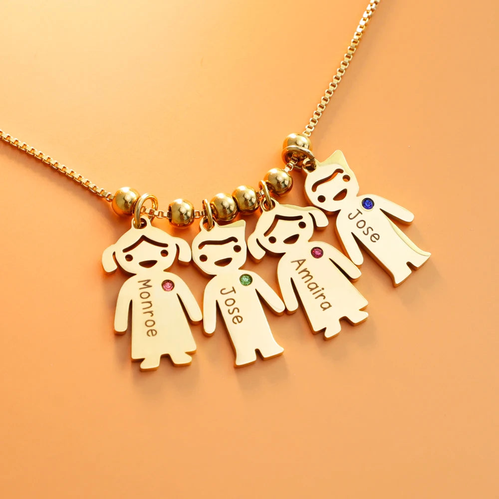 Gold necklace with four child-shaped pendants on an orange background