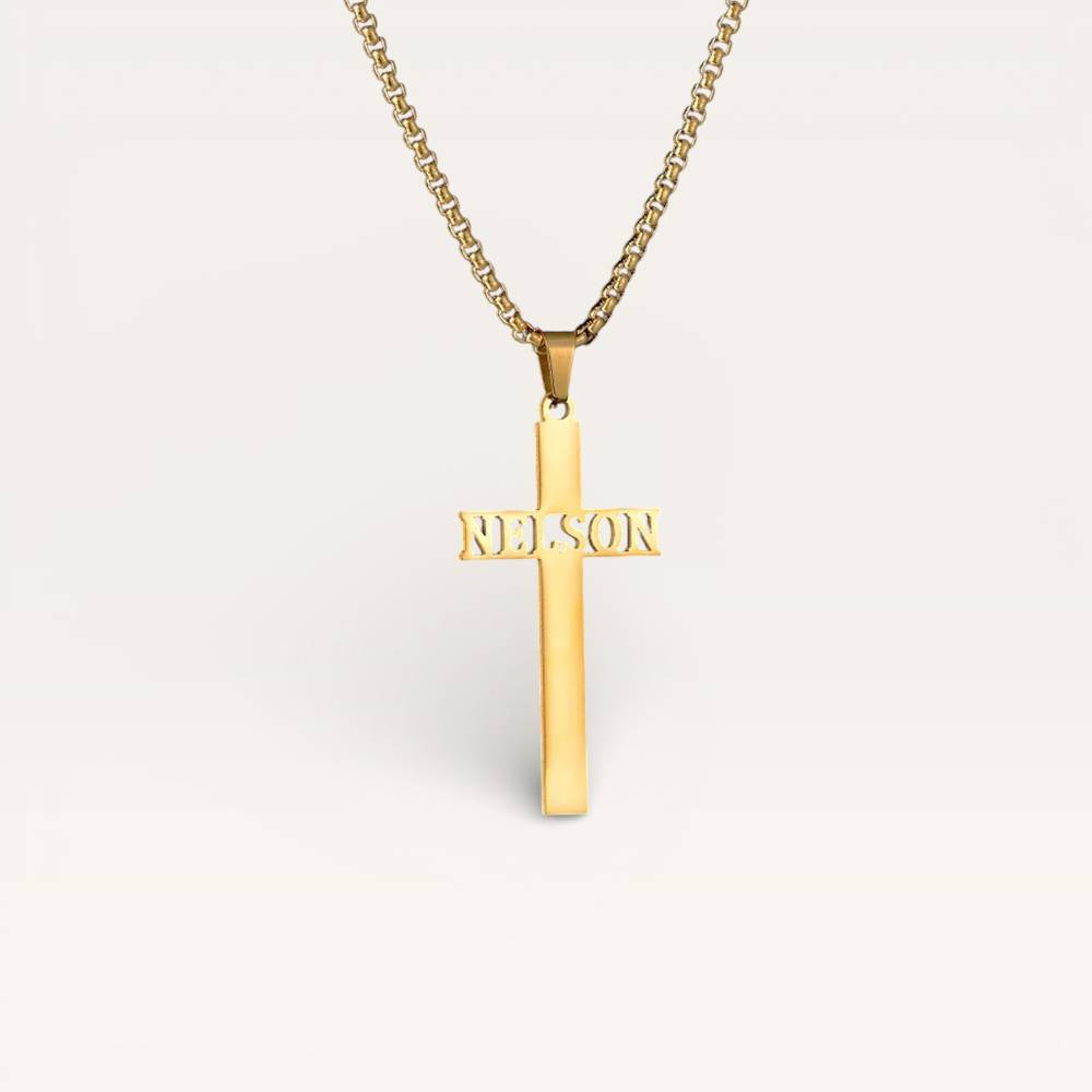Gold cross pendant with 'Nelson' engraving on a white background